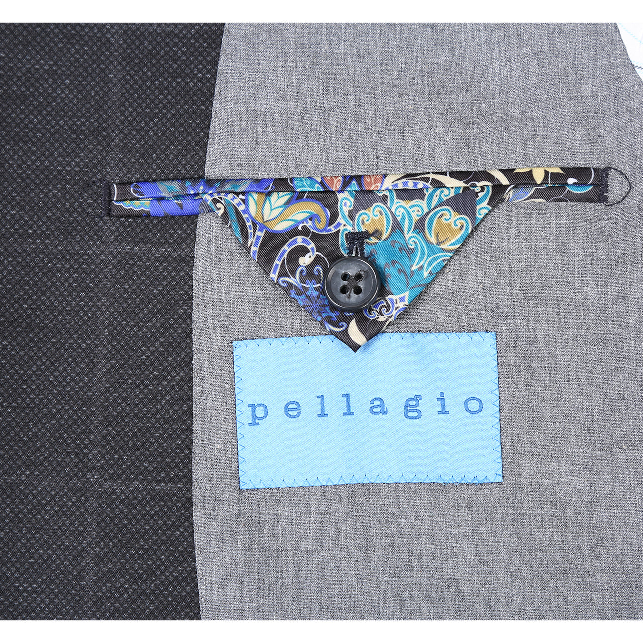 The Pellagio Ink Blue Men's Half Canvas Blazer PF24-7, featuring a single-breasted design and notched lapel, drapes elegantly on the mannequin over a crisp white shirt. A red polka dot tie and patterned pocket square complete the sophisticated ensemble.