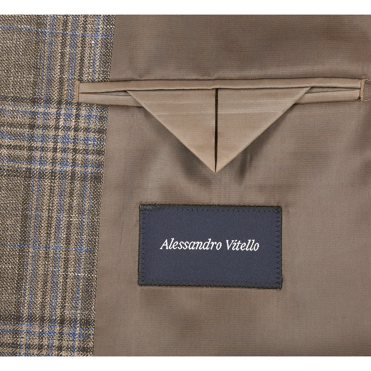 The Renoir Alessandro Vitello by Renoir New Slim Fit Sport Coat 565-18, shown on a mannequin with a white shirt, green patterned tie, and pocket square, features refined wool-linen fabric in a brown plaid for effortless style.