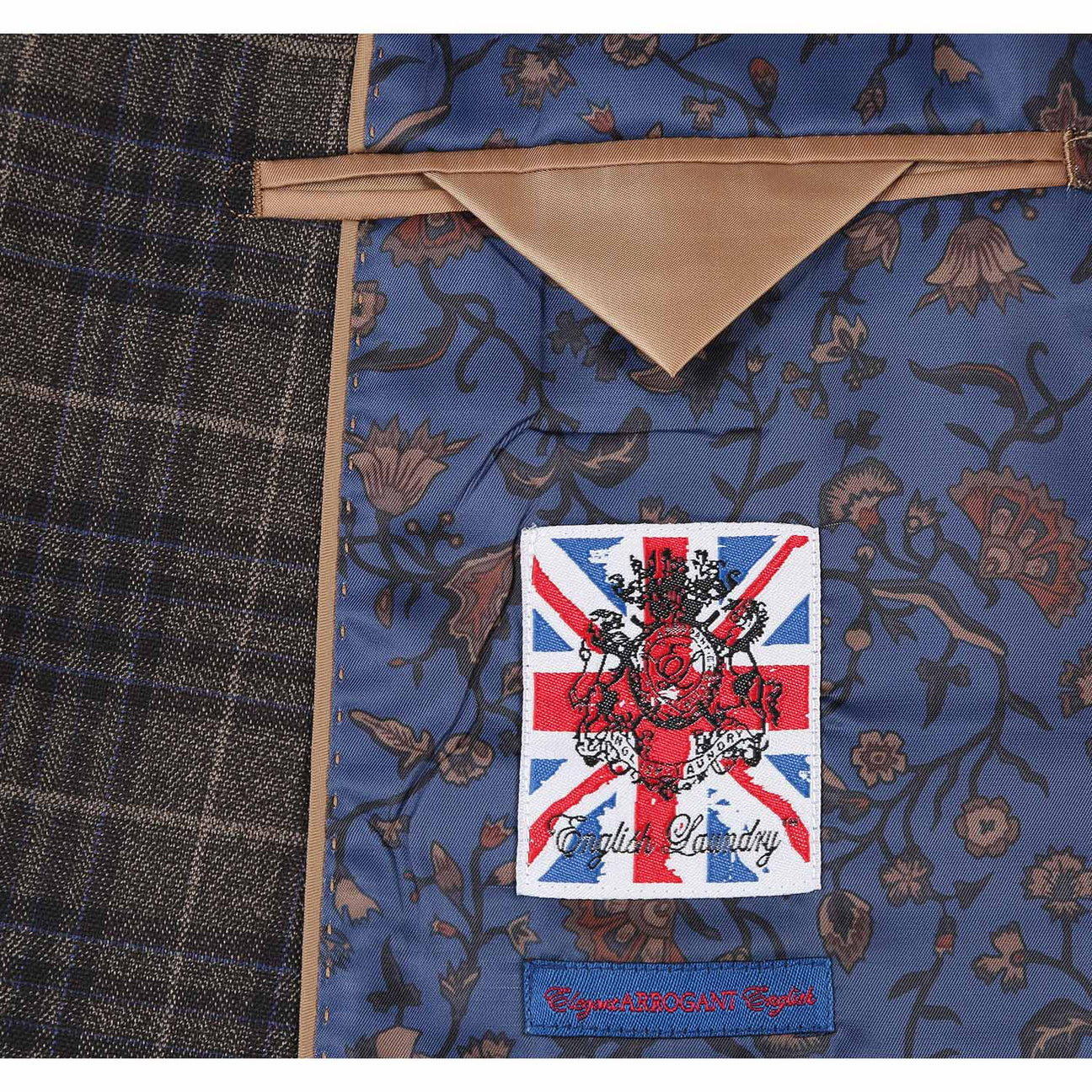 The mannequin is adorned in an English Laundry three-piece sand brown check suit, featuring a sleek jacket that drapes elegantly over a white dress shirt, complemented by a maroon polka dot tie.