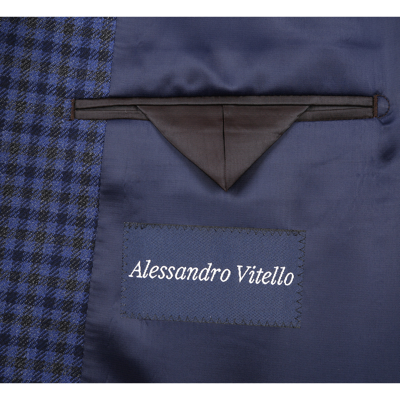The Renoir Alessandro Vitello Classic Fit Wool Blue Blazer 565-9 is shown on a mannequin with a white dress shirt and blue patterned tie, featuring a notch lapel and a blue and black checkered pattern.