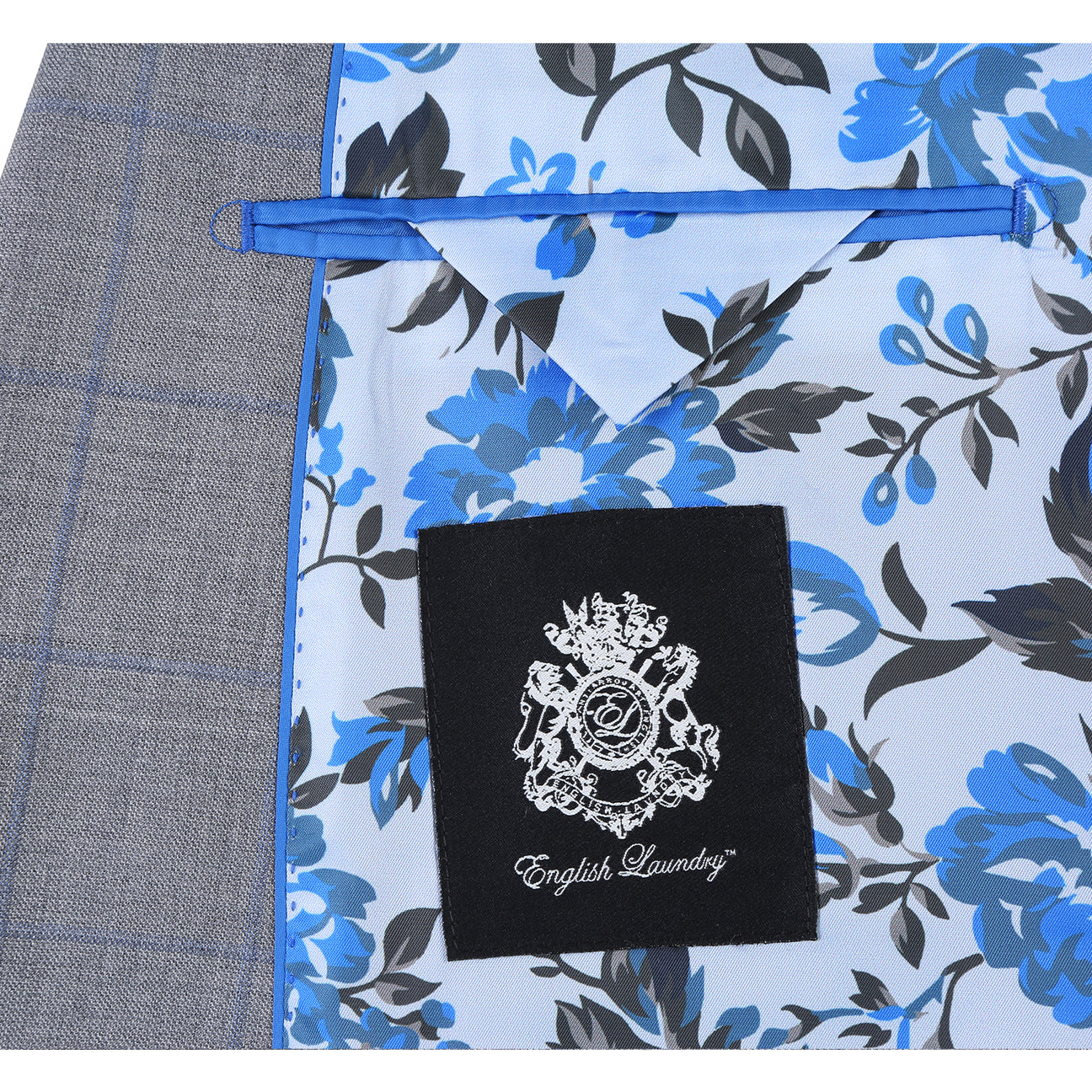 The ENGLISH LAUNDRY Wool Suit EL92-55-092 by English Laundry is a gray plaid wool slim-fit jacket with notch lapels, two buttons, and flap pockets, displayed over a white shirt and blue tie on a mannequin.