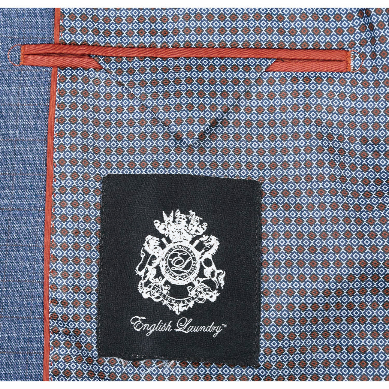 The ENGLISH LAUNDRY Pale Blue Wool Suit EL82-60-402, featuring a slim fit with a subtle check pattern and stylish notch lapels, pairs perfectly with a crisp white dress shirt and an orange patterned tie, elegantly displayed on a mannequin.