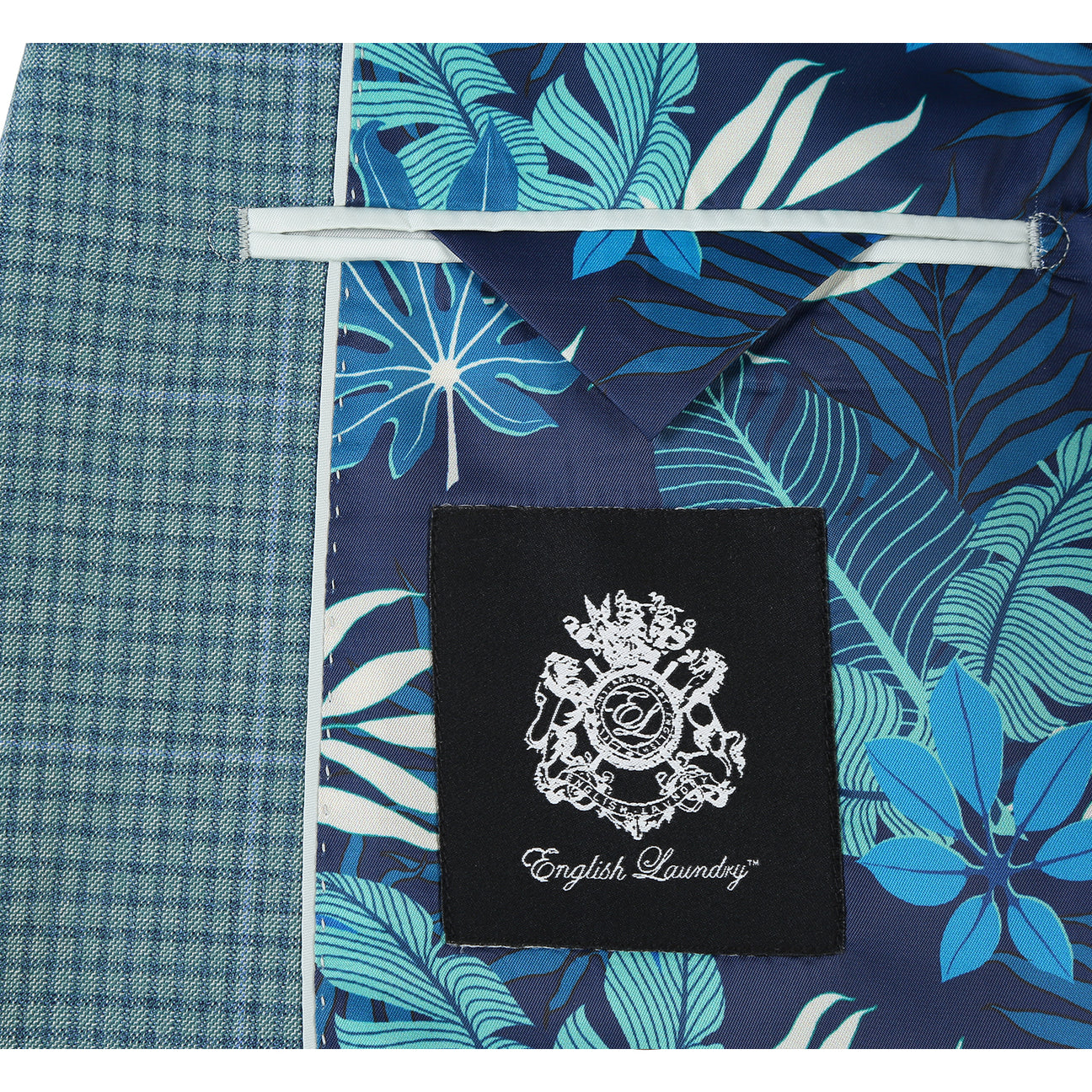 The ENGLISH LAUNDRY Grey Wool Suit EL92-53-341 by English Laundry features a slim fit wool jacket with notch lapels, styled on a mannequin with a white dress shirt and red patterned tie for a modern, tailored look.