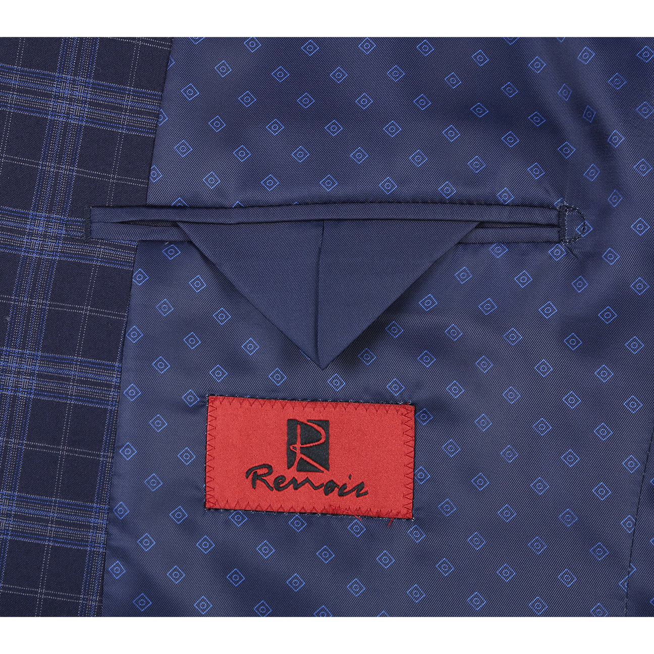 The Alessandro Vitello by Renoir slim fit suit jacket in navy, with a two-button closure, is showcased on a mannequin with a white shirt and maroon polka dot tie, made from a stylish blend of polyester, rayon, and spandex.