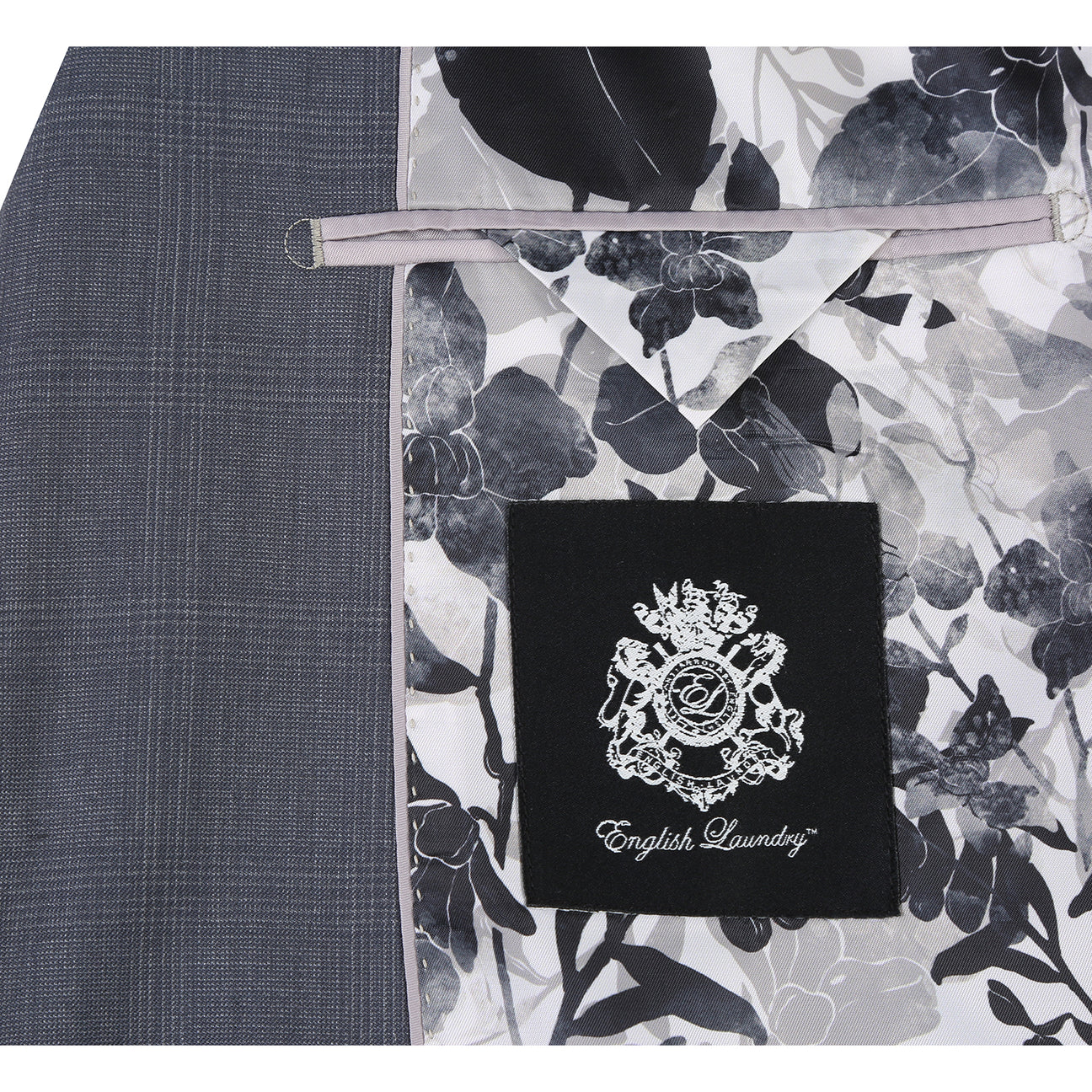 The English Laundry Grey Wool Suit EL92-58-095 features a slim fit, notch lapels, two buttons, and flap pockets. Crafted from 90% wool, it's displayed over a white dress shirt and navy striped tie on a mannequin.