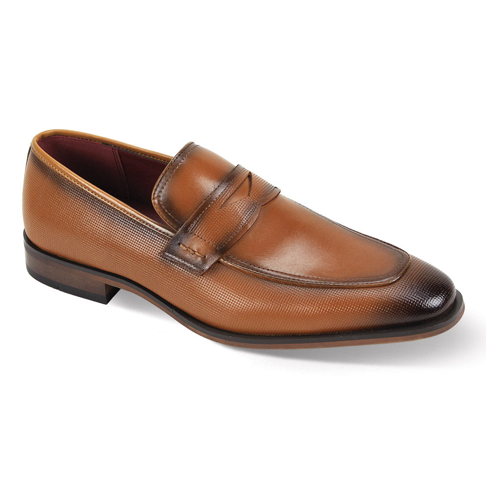The Giorgio Venturi Giorgio 7043 Tan Leather Shoes feature a classic penny loafer style with a moc toe, textured finish, darkened toe and heel, low heel, and signature strap across the upper.