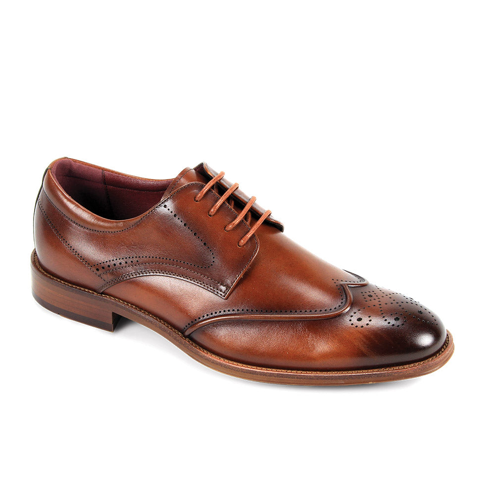 The Giorgio Venturi Giorgio 7077 Tan Leather Shoe is a single genuine leather dress shoe with wingtip brogue detailing, laces, and a low heel, displayed against a white background.