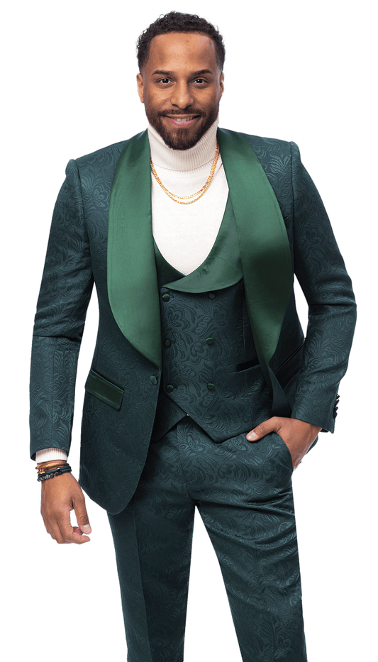 A man wearing the EJ SAMUEL Hunter Suit JP138, styled with a white turtleneck and gold necklaces, stands with one hand in his pocket and smiles.