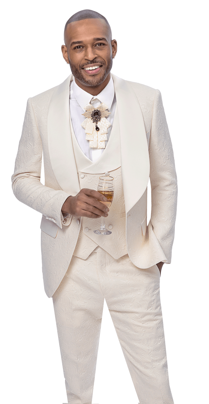 A man wearing the EJ SAMUEL Cream Suit JP138, a stylish 3-piece tuxedo with vest and bow tie, holds a glass of champagne and smiles at the camera.