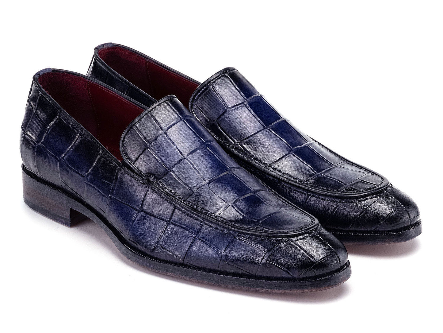 The Paul Parkman Croco Textured Leather Loafer Blue - 7339-BLU, a pair of blue men's loafers with crocodile texture, is shown on a white background—one shoe upright, the other leaning diagonally against it.