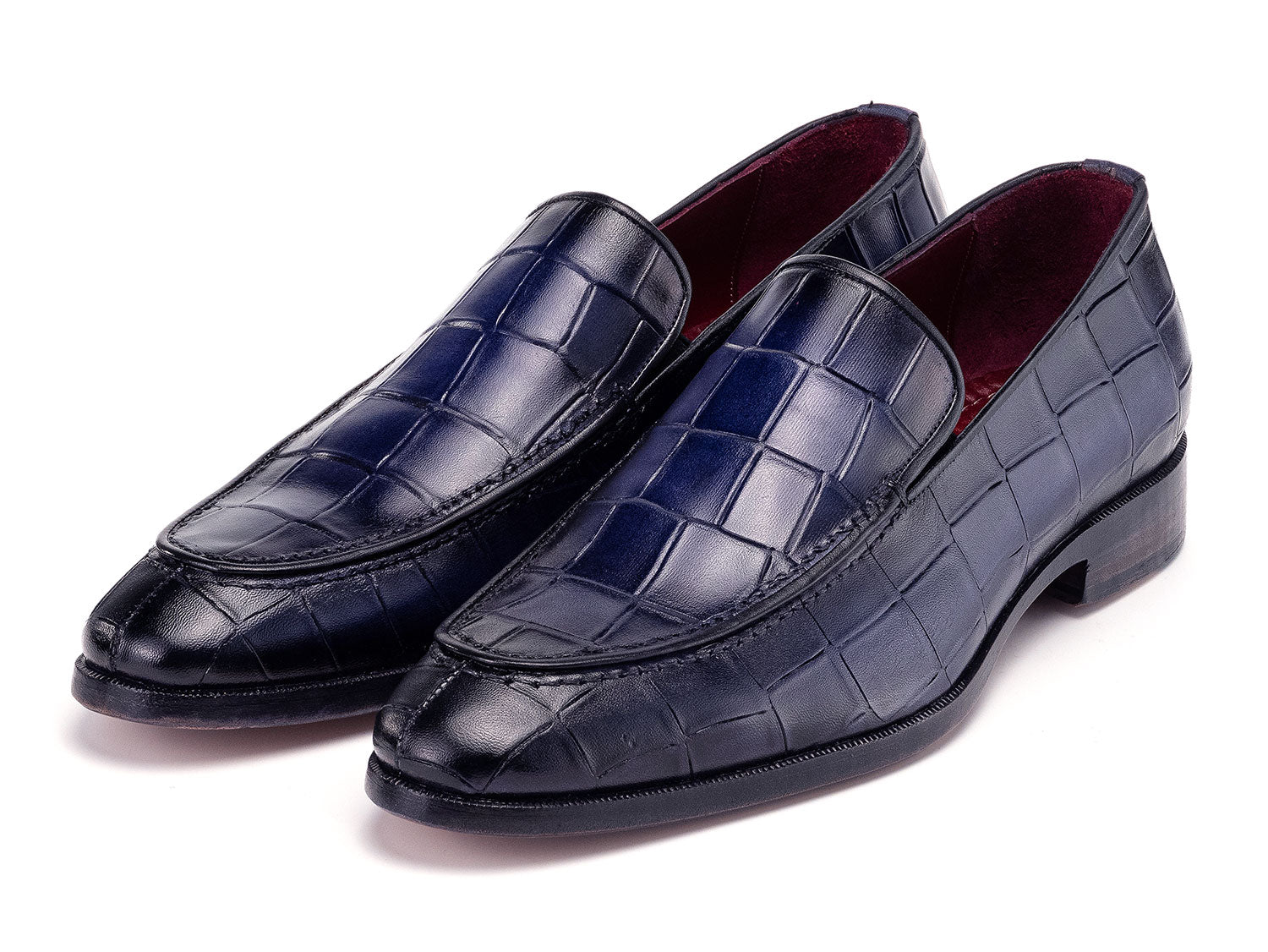 The Paul Parkman Croco Textured Leather Loafer Blue - 7339-BLU, a pair of blue men's loafers with crocodile texture, is shown on a white background—one shoe upright, the other leaning diagonally against it.