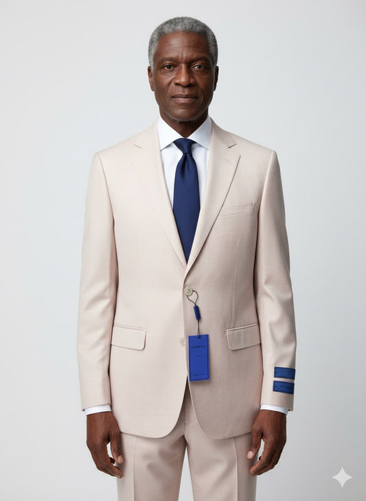 The Cavelli Uomo Porto Slim Fit Suit 1986/20 in blush by CAVELLI, featuring beige buttons and a blue tag, is displayed on a hanger and laid flat on a gray wooden floor. (FINAL SALE—NO RETURN OR EXCHANGE).