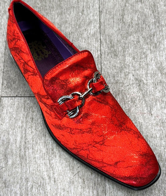 An Exclusive Formal Dress Shoe Red SUTTON by UNIQUE DESIGN MENSWEAR, crafted from genuine leather and featuring a metallic buckle detail, rests elegantly on a gray wooden floor.