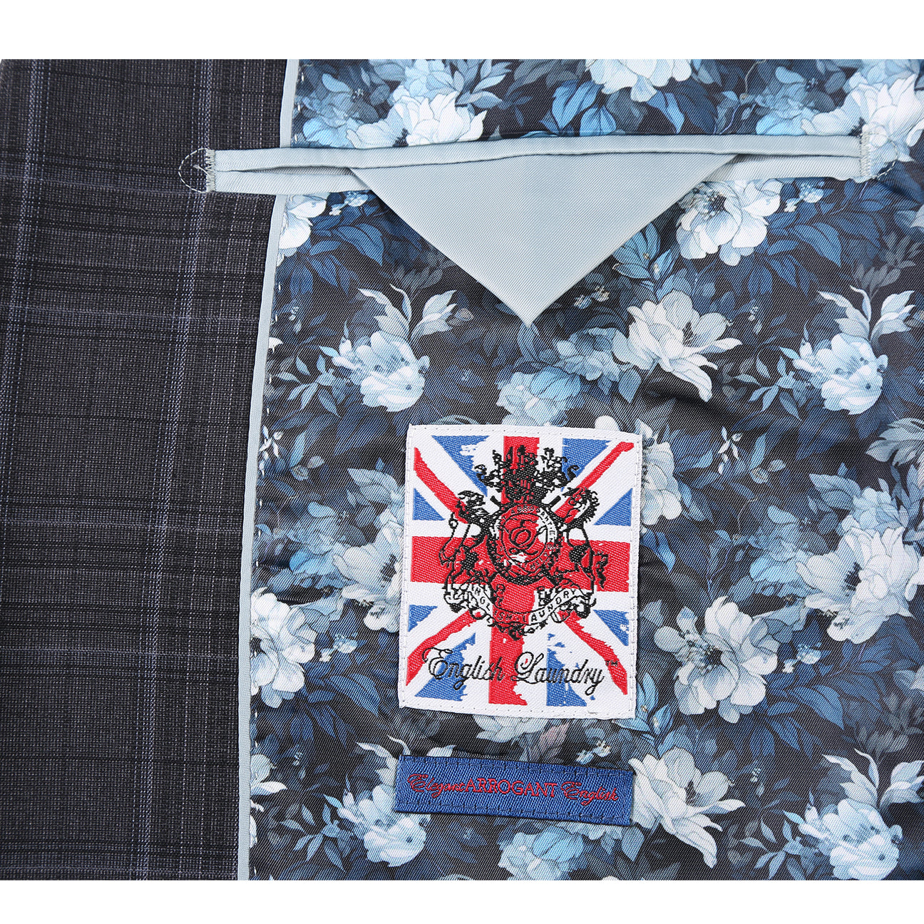 The ENGLISH LAUNDRY Dark Gray Check Suit 22-57-095EL by English Laundry features a slim fit, black and gray plaid design with a two-button closure, styled over a white shirt and blue patterned tie on a mannequin.