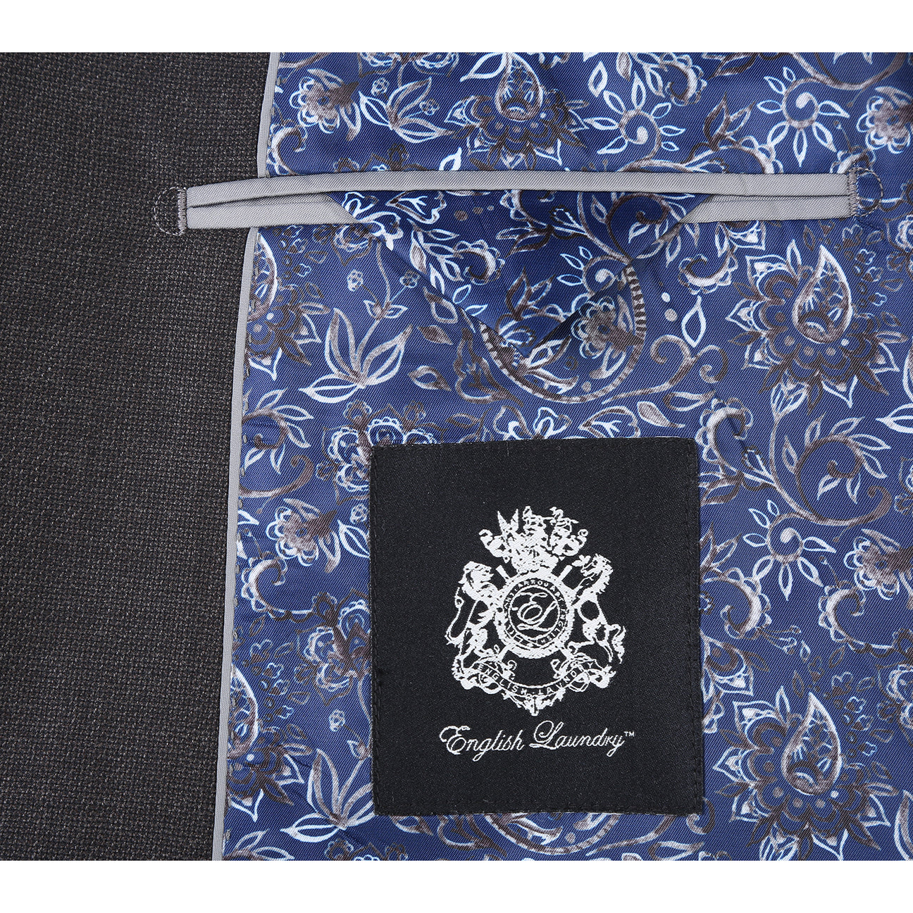 The ENGLISH LAUNDRY Dark Gray Suit EL12-02-095 by English Laundry, styled on a mannequin with a white dress shirt and black, gray, and silver striped tie, offers a refined slim fit suit look.