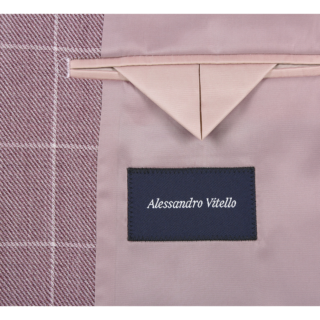 The Renoir Alessandro Vitello by Renoir New Slim Fit Sport Coat 565-16, a mauve checkered 100% wool jacket with notch lapels, is shown on a mannequin with a white shirt, green patterned tie, and pocket square.