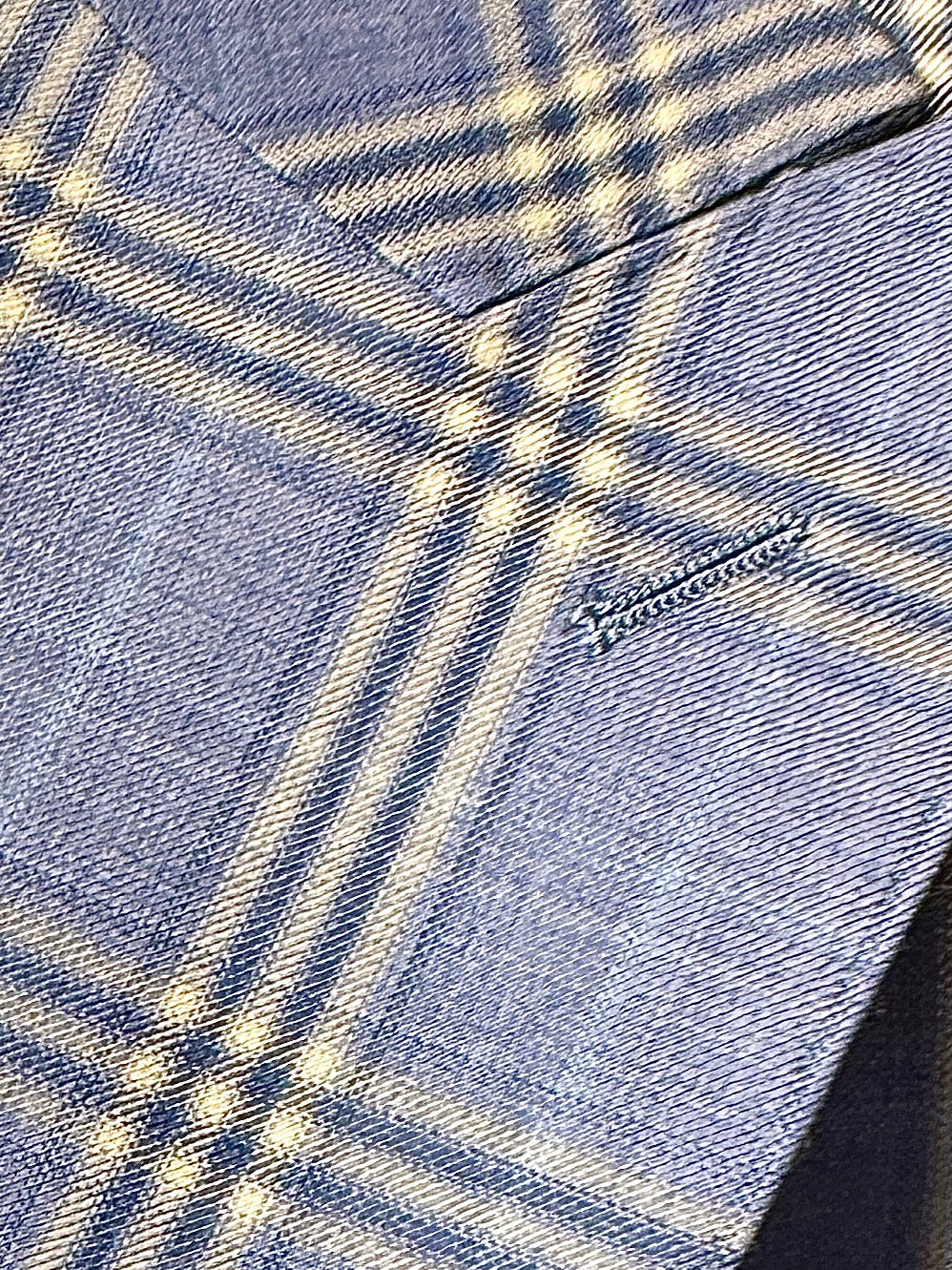 A man stands facing forward against a white background, dressed in the Tiglio Rosso Orvietto Blue Plaid Semi Wide Leg TL9337 three piece suit by Tiglio Rosso, paired with a white shirt and patterned tie.