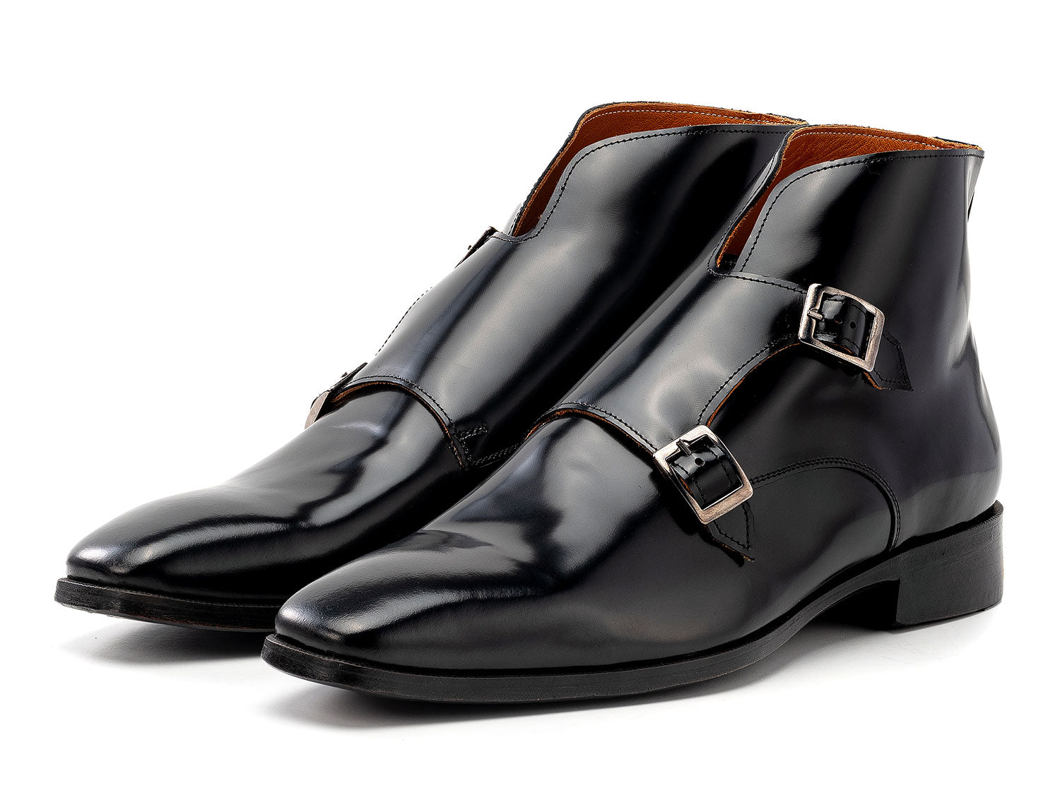 The Paul Parkman Double Monkstrap Ankle Boots in black polished leather (model 8154-BLP) feature side buckles; one men's boot stands upright while the other is balanced on top.