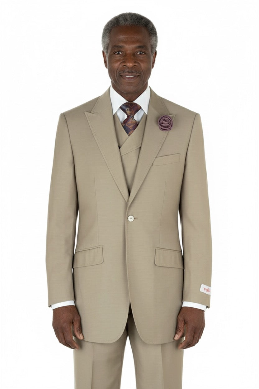 Displayed on a mannequin, the Tiglio Rosso San Giovesse Solid Tan TIG1004 three-piece suit is complemented by a white shirt, patterned tie, and purple lapel flower.