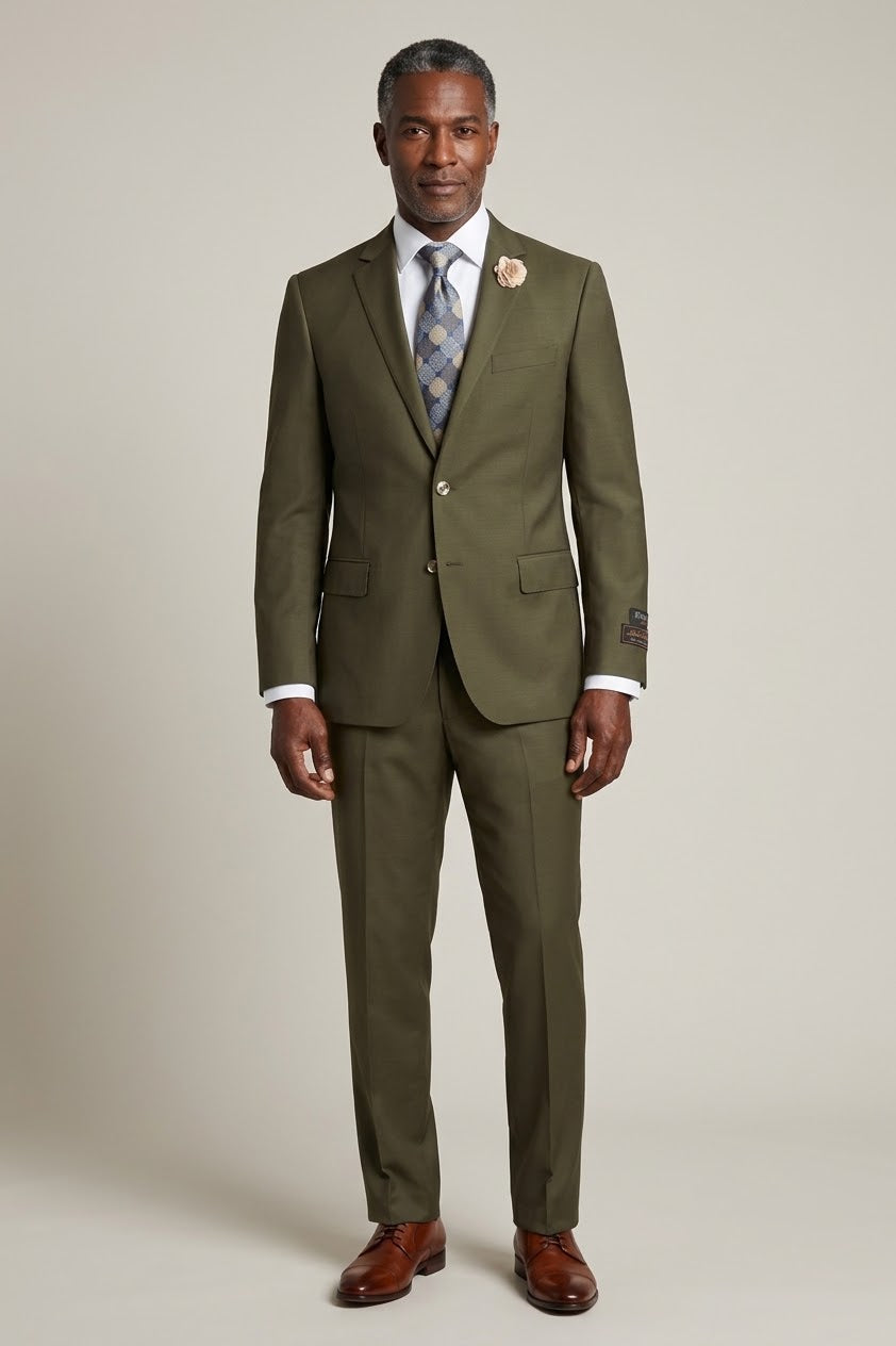 A mannequin displays the Tiglio Luxe Novello Olive Suit from Tiglio, featuring a European fit and accompanied by a white shirt, patterned tie, and a beige floral lapel pin.