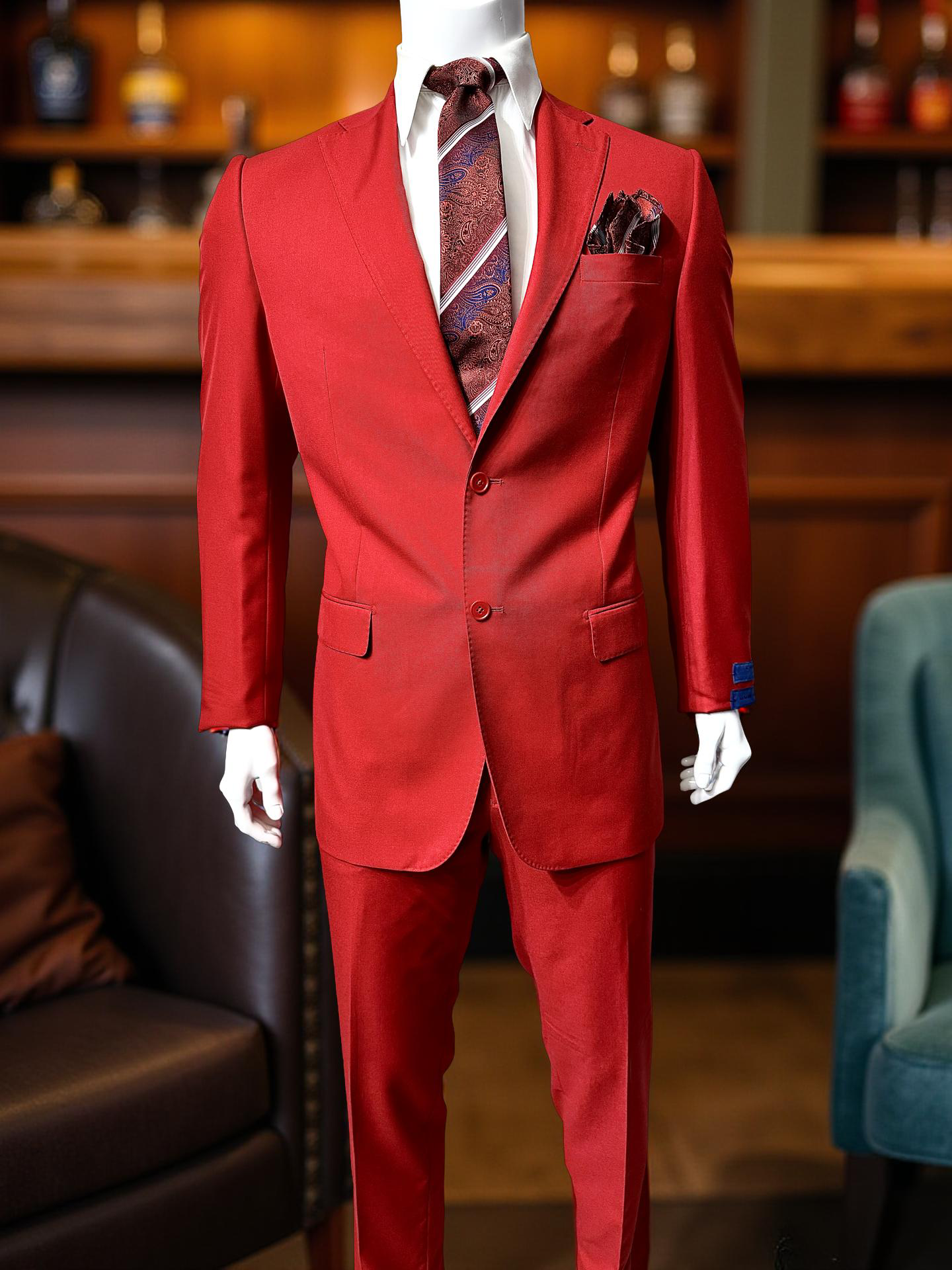 A mannequin displays the Cavellini Uomo Dolcetto MODERN FIT Suit 6667/62 by CAVELLI, styled with a patterned tie and pocket square, standing in a lounge with chairs and a wooden bar in the background.