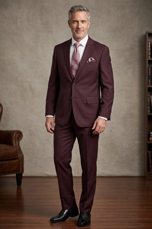 The Tiglio Luxe Novello Burgundy Suit showcases a refined European fit, complete with a geometric patterned tie and matching pocket square on a sleek white shirt, all meticulously crafted from exquisite Italian wool by Tiglio.