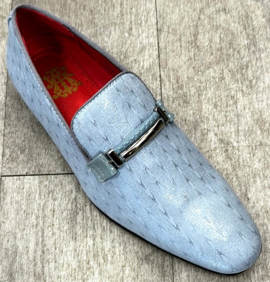 The Exclusive Formal Dress Shoe Grey 6993 by UNIQUE DESIGN MENSWEAR is a light blue shoe crafted from genuine suede leather, featuring a metal buckle detail and a red inner lining, elegantly placed on a gray tiled floor.