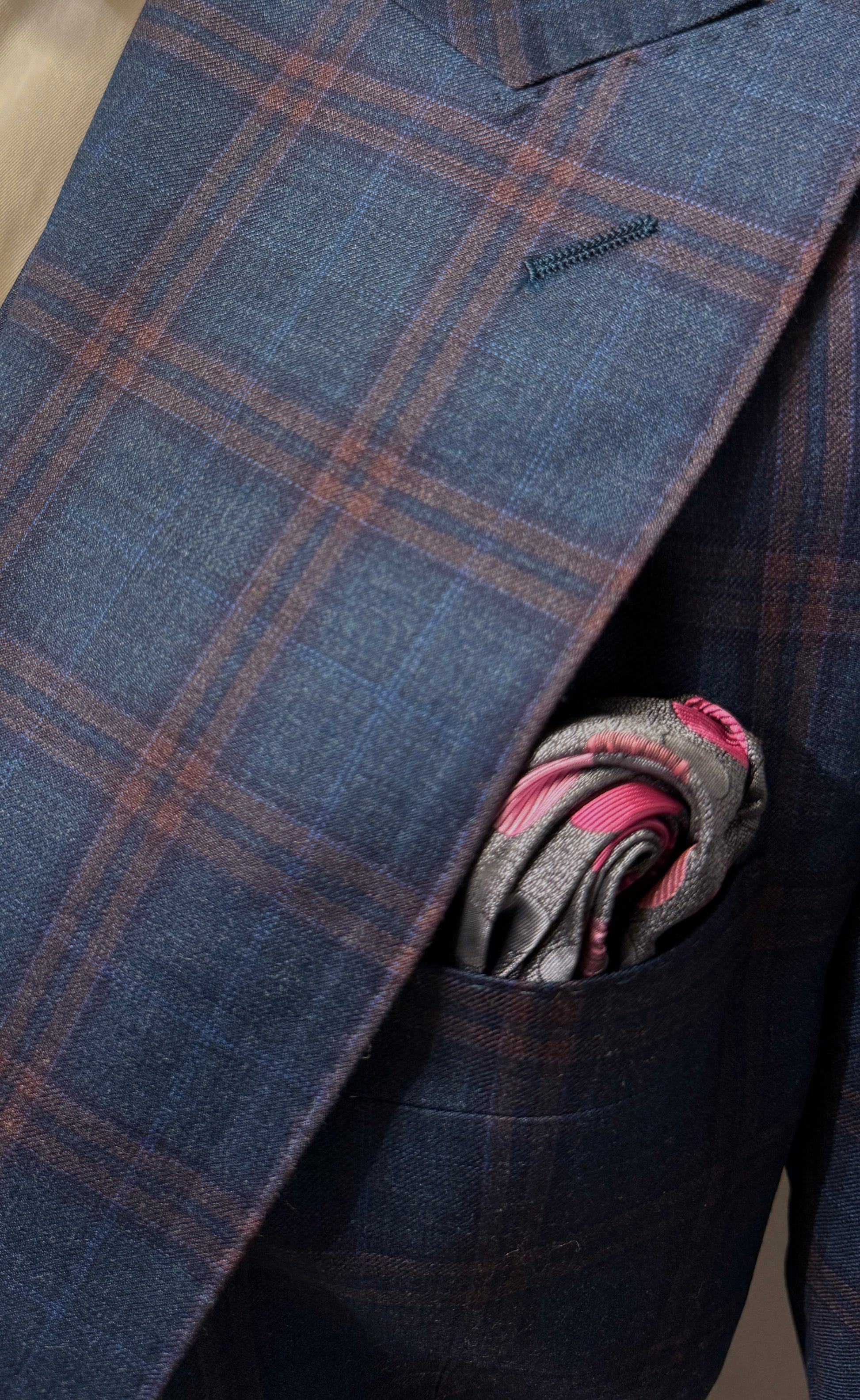 An older man wears a Tiglio Rosso Orvietto Teal Blue/Rust Window Pane suit (TL9340) with a white shirt and patterned tie, standing against a plain background.