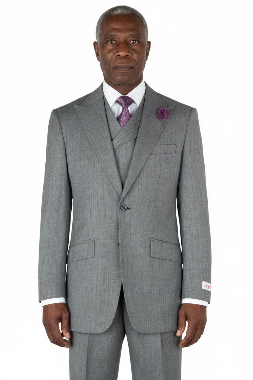 On display, the Tiglio Rosso San Giovesse Grey Birdseye TIG1018 three-piece suit exudes elegance on a mannequin, complemented by a crisp white shirt, a purple tie, and a matching pocket square.