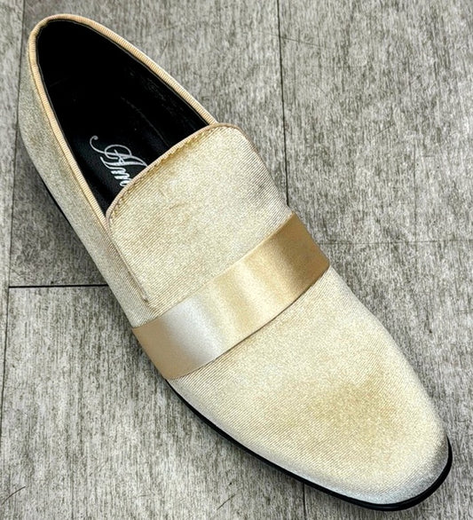 An Exclusive Formal Dress Shoe Tan 7021 from UNIQUE DESIGN MENSWEAR, featuring a gleaming strap and crafted from genuine leather, gracefully sits on a textured gray surface, radiating an aura of Italian craftsmanship.