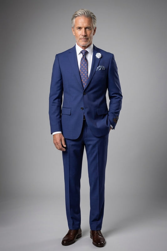 A mannequin dressed in the Tiglio Luxe Novello Modern Fit French Blue suit from Unique Design Menswear, perfectly complemented by a white shirt, patterned tie, pocket square, and a white lapel flower exudes artistry and sophistication.