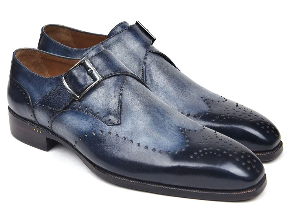 The Paul Parkman Wingtip Single Monkstraps Navy - 98F54-NVY are handmade navy leather shoes with wingtip perforations and a buckle closure, displayed on a white background.