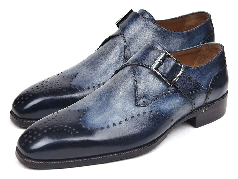 The Paul Parkman Wingtip Single Monkstraps Navy - 98F54-NVY are handmade navy leather shoes with wingtip perforations and a buckle closure, displayed on a white background.