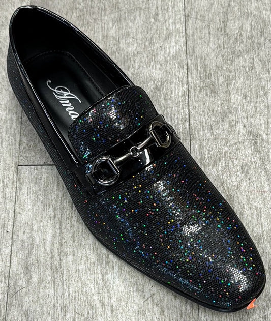 The Exclusive Formal Dress Shoe Black SUTTON by UNIQUE DESIGN MENSWEAR, crafted from genuine leather, features a sparkling design with a metal buckle detail, set against a gray background.