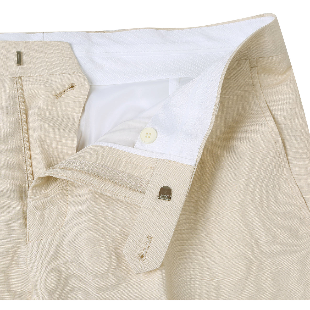 A chic champagne suit jacket from the Alessandro Vitello by Renoir collection, distinguished by a notch lapel and offering a new slim fit, pairs perfectly with a blue tie and crisp white shirt on the mannequin.