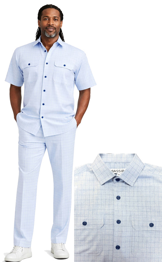 A man wears the Bassiri Blue 2pc Set A 144 by Bassiri—light blue, short-sleeve button-up shirt and matching check-pattern pants with white sneakers; close-up displays shirt collar and buttons.