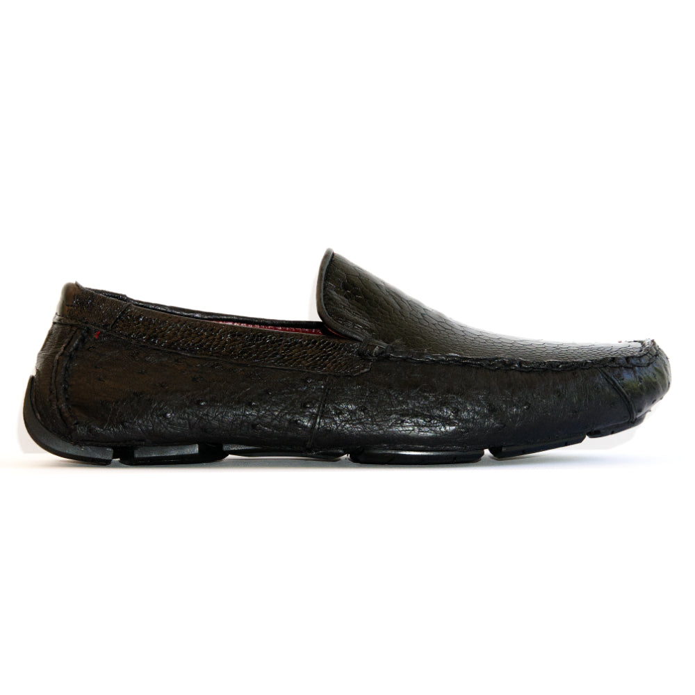 A pair of Marco Di Milano Alba Black luxury moccasin loafers—one upright and the other leaning against it—showcasing detailed stitching and a sole expertly crafted from genuine ostrich leather for an unmistakably exotic driver style.
