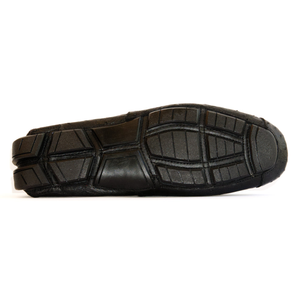 A pair of Marco Di Milano Alba Black luxury moccasin loafers—one upright and the other leaning against it—showcasing detailed stitching and a sole expertly crafted from genuine ostrich leather for an unmistakably exotic driver style.