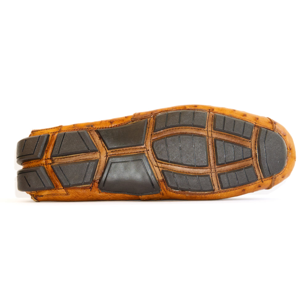 A pair of Alba Brandy luxury moccasin loafers by Marco Di Milano, crafted from genuine tan ostrich leather with a distinctive textured surface and black rubber soles—one shoe displayed upright and the other shown lying on its side.