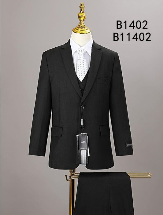 The BOY SUIT 5-PC SET B1402 by Unique Design Menswear is shown on a mannequin with a white shirt and polka dot tie, featuring visible suit tags—a sleek black formal set ideal for special occasions.