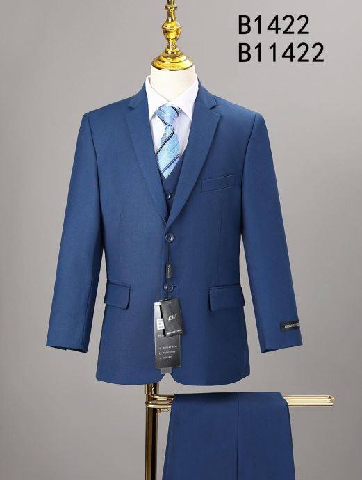 A Unique Design Menswear BOY SUIT 5-PC SET B1422 (IN STORE), blue, with tie and white shirt, is shown on a mannequin. Trousers are draped below, with tags attached. Text "B1422 B11422" appears in the top right corner.