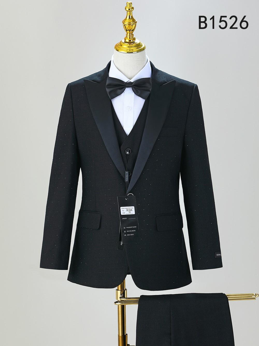 A black boys' five-piece formal suit set (BOY SUIT 5-PC SET B1526) by Unique Design Menswear, featuring satin lapels, white shirt, and black bow tie, displayed on a mannequin.
