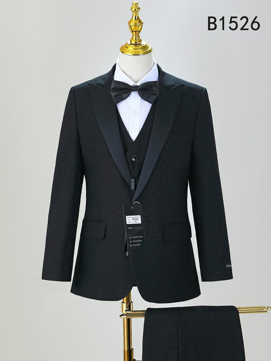 A black boys' five-piece formal suit set (BOY SUIT 5-PC SET B1526) by Unique Design Menswear, featuring satin lapels, white shirt, and black bow tie, displayed on a mannequin.