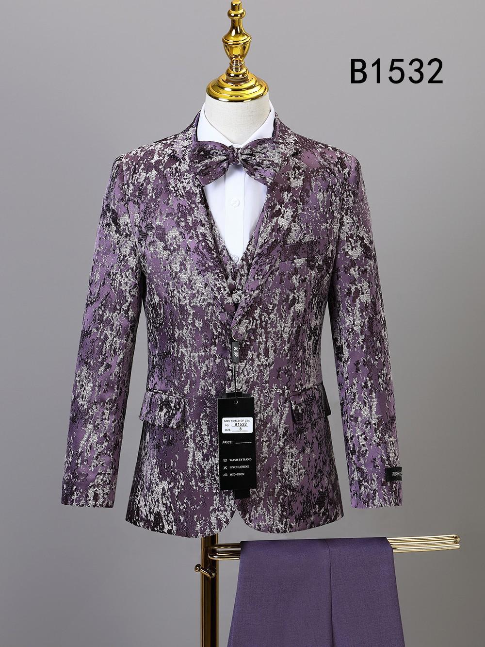The BOY SUIT 5-PC SET B1532 by Unique Design Menswear, in purple and silver pattern with matching bow tie and pants, is showcased on a mannequin with tag. "B1532" appears in the upper right, ideal for boys’ formal occasions.