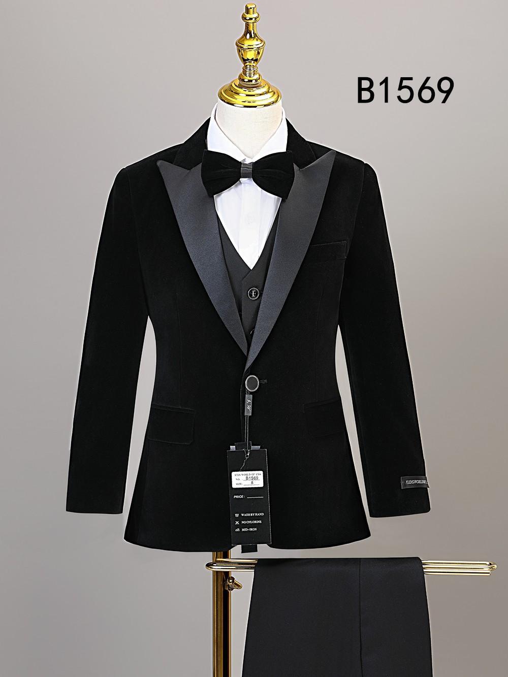 The BOY SUIT 5-PC SET B1569 by Unique Design Menswear features a black velvet suit with satin lapels, white dress shirt, black bow tie, and matching trousers—perfect boys formal wear for special occasions.