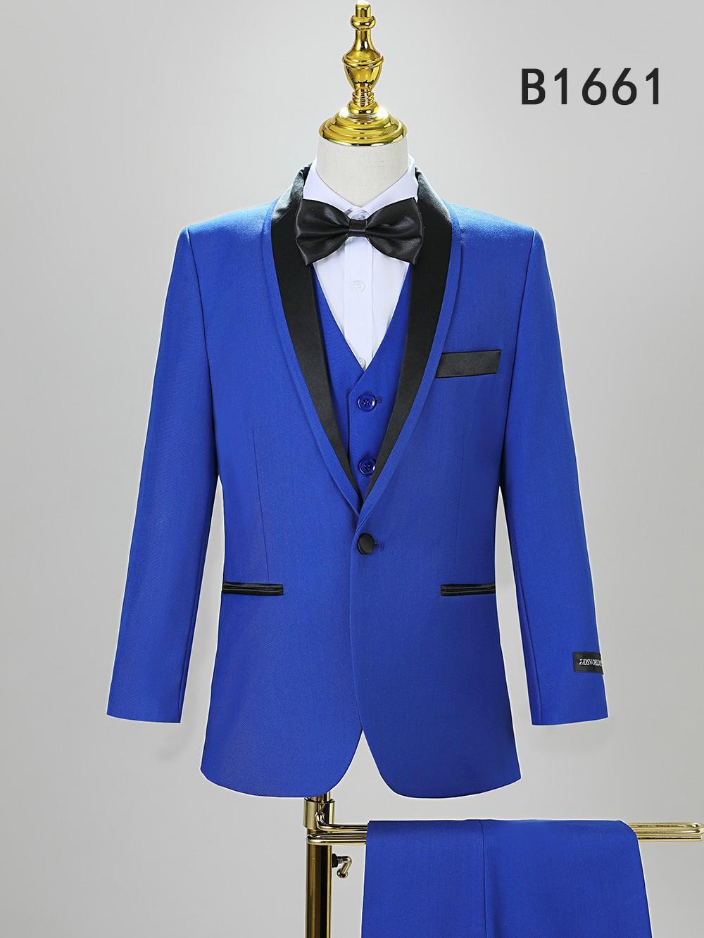 Displayed on a mannequin, the BOY SUIT 5-PC SET B1661 by Unique Design Menswear features a royal blue jacket with black lapels, matching vest, black bow tie, and pocket accents—ideal boys’ formal wear for special occasions.