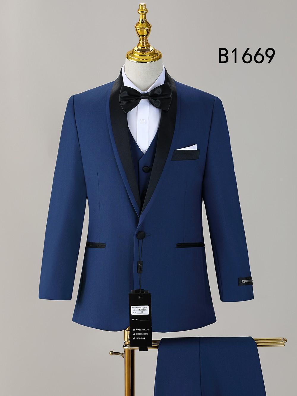 The Unique Design Menswear BOY SUIT 5-PC SET B1669 features a blue tuxedo with black lapels, white shirt, black bow tie, pocket square, and pants on display; tag attached. "B1669" is shown in the upper right corner. Perfect for boys’ formal wear.