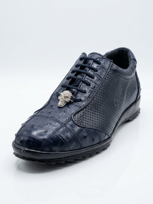 Introducing the Los Altos Avestruz Perforated Ostrich Lace Up Casuals in Navy by Los Altos—a navy blue sneaker crafted from genuine ostrich leather, featuring a textured finish, perforated side panel accents, and a metallic skull ornament on the laces, photographed against a white background.
