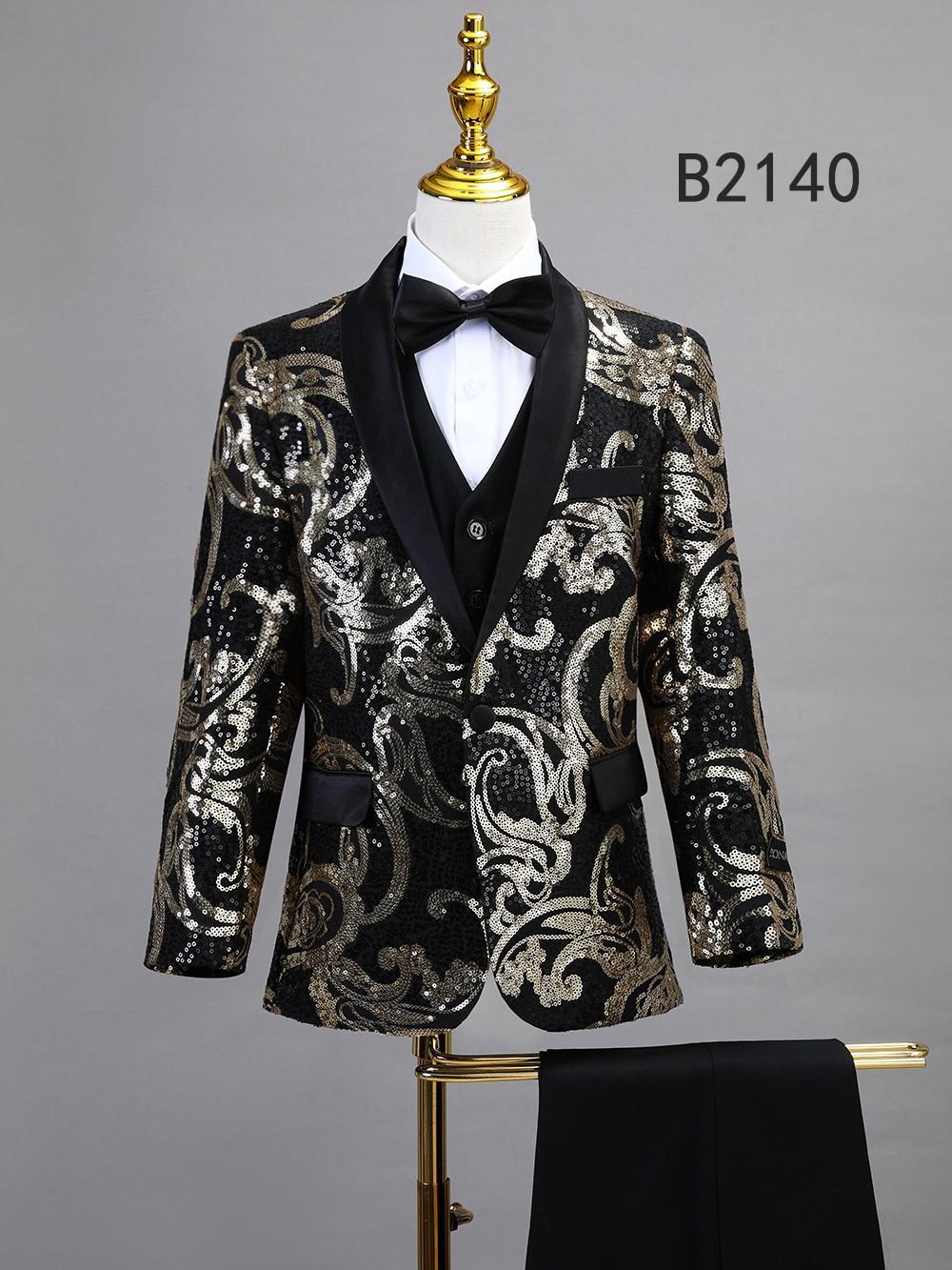 A mannequin displays the Unique Design Menswear BOY SUIT 5-PC SET B2140: a black tuxedo jacket with silver sequin swirls, black lapels, black bow tie, and white dress shirt—perfect for boys’ formal wear.
