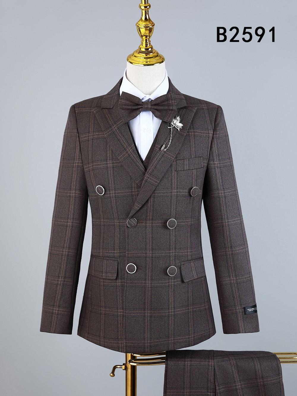 The Unique Design Menswear BOY SUIT 5-PC SET B2591 features a brown plaid double-breasted jacket with silver buttons, pants, vest, white shirt, bow tie, and decorative pin. Kids formal wear displayed on mannequin; code B2591 shown top right.